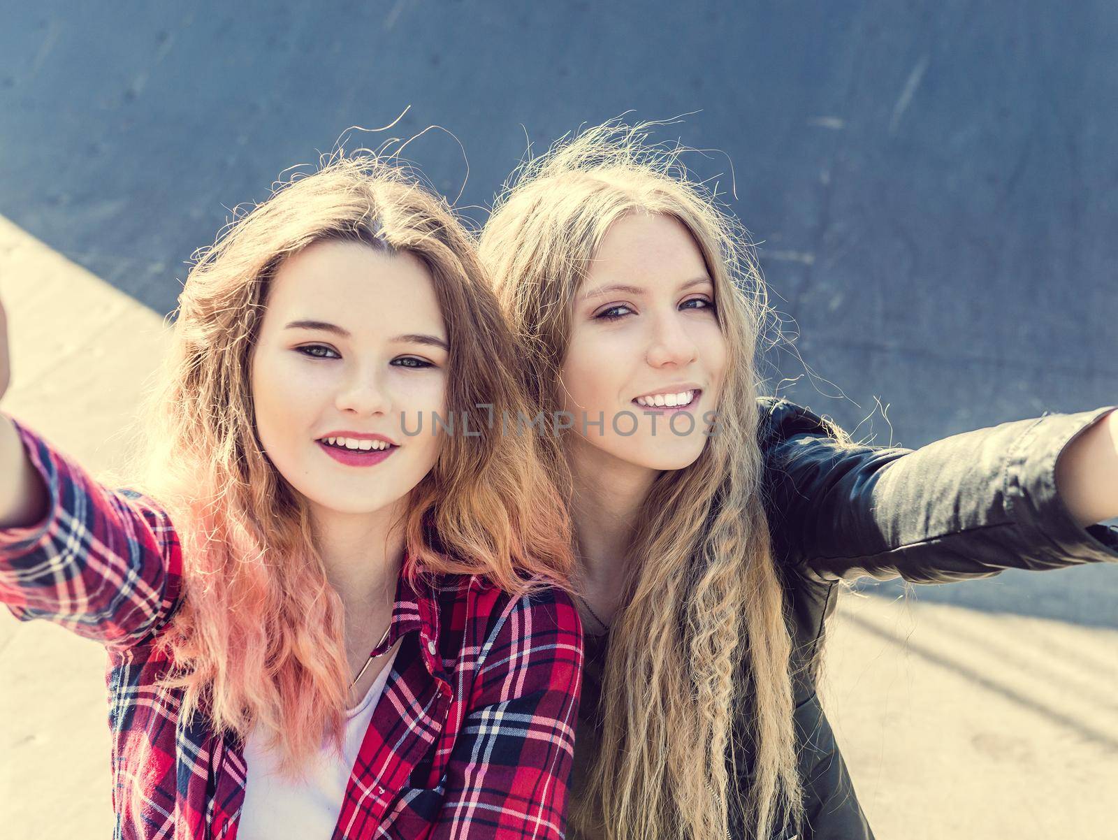 Happy girl friends taking a selfie on a summer day by tan4ikk1
