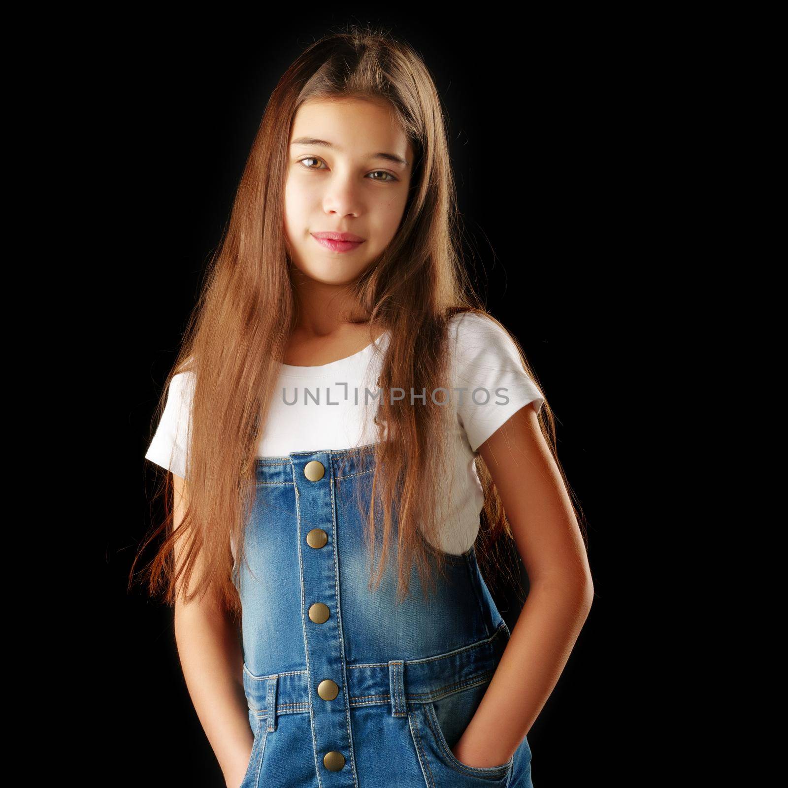 Beautiful little girl on a black background. Studio photography