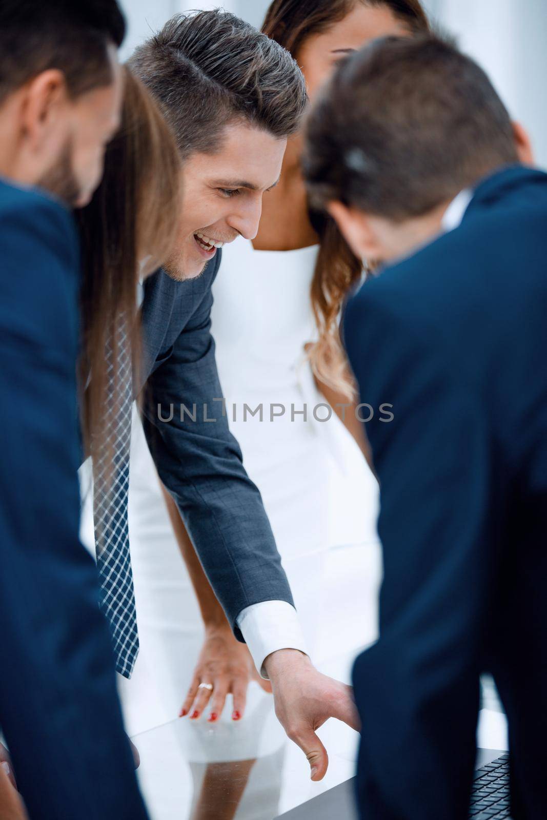 close up.smiling business team using a laptop by asdf