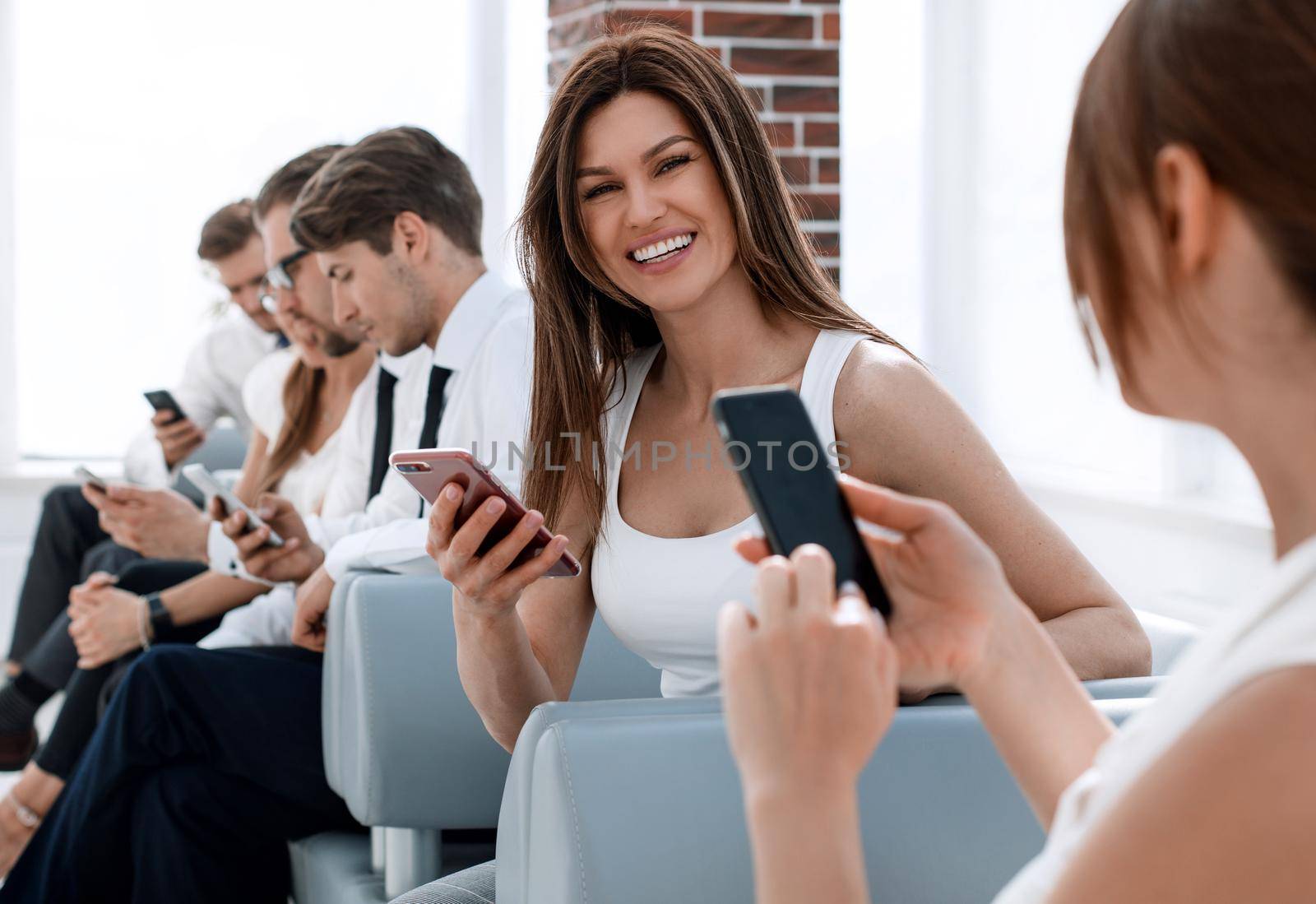 young colleagues sitting in the office hallway.people and technology