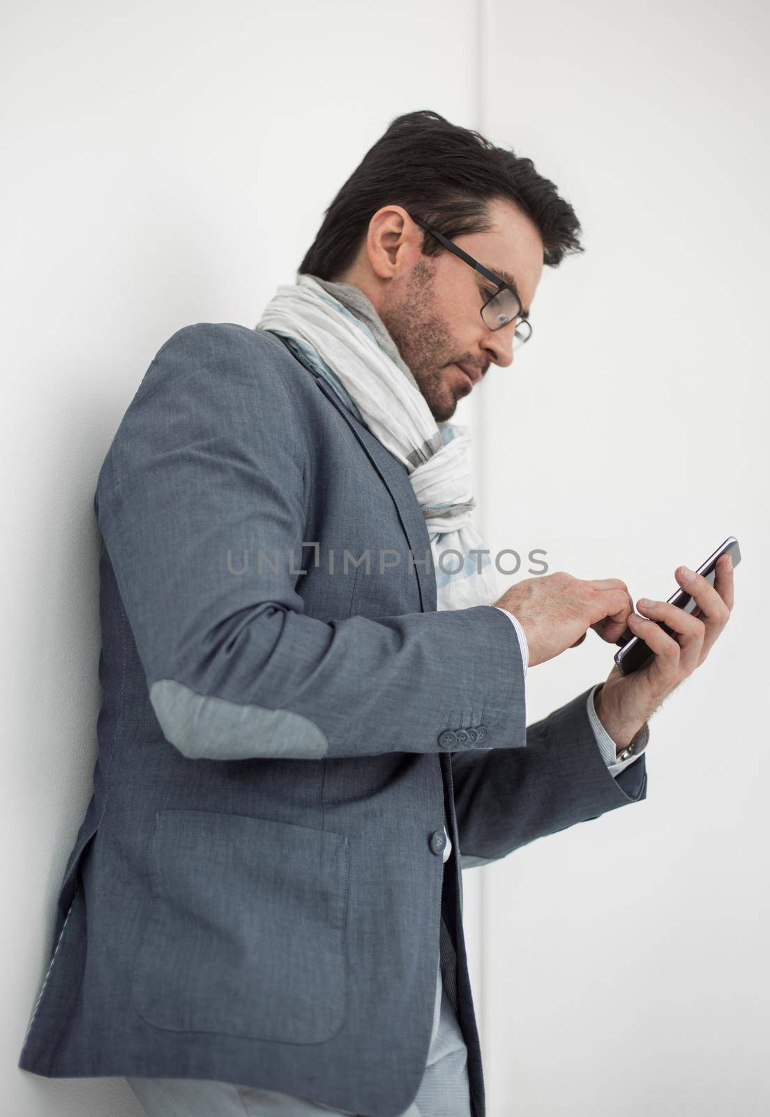 serious business man typing SMS on smartphone by asdf