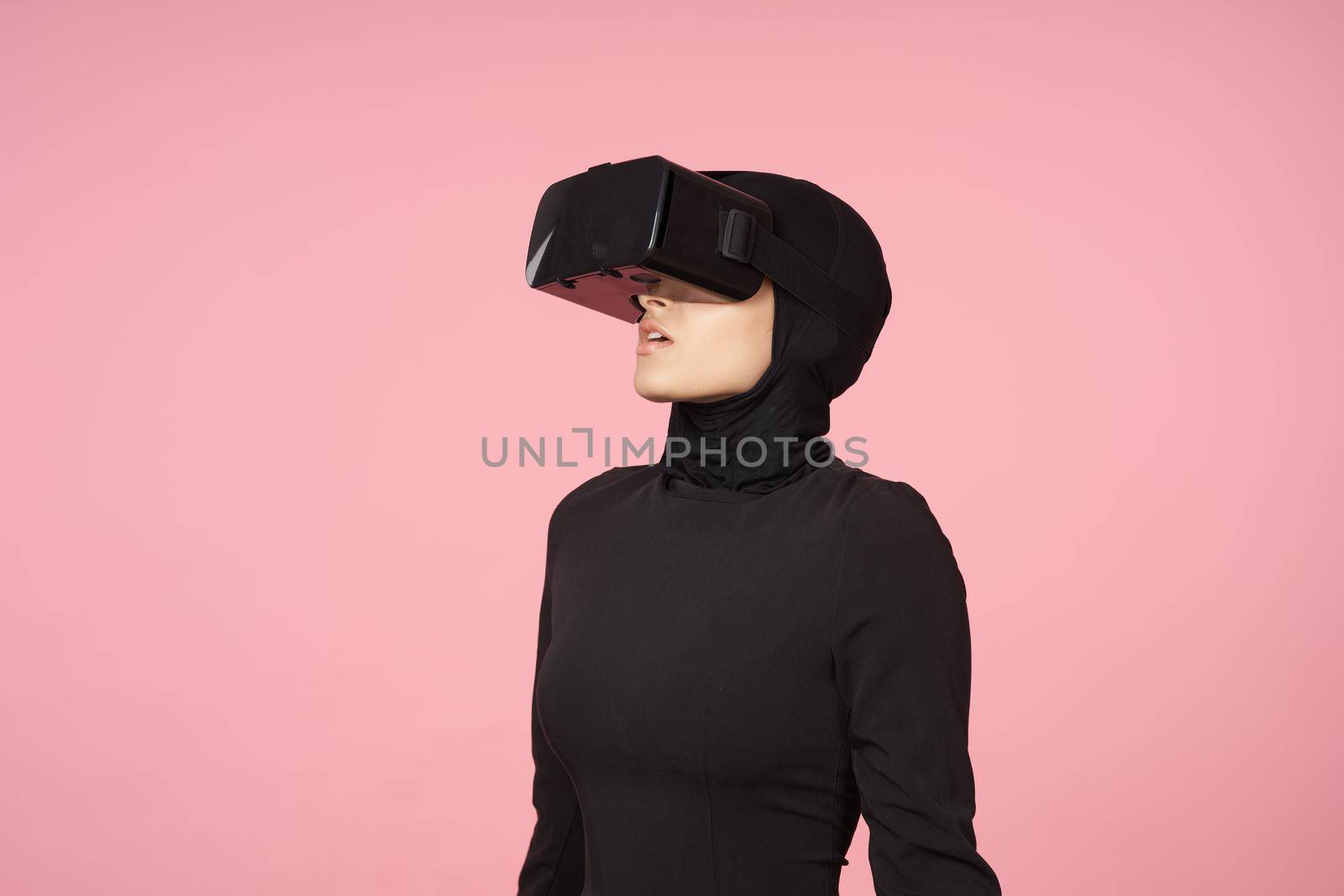woman in black hijab glasses virtual reality technology movie watching. High quality photo
