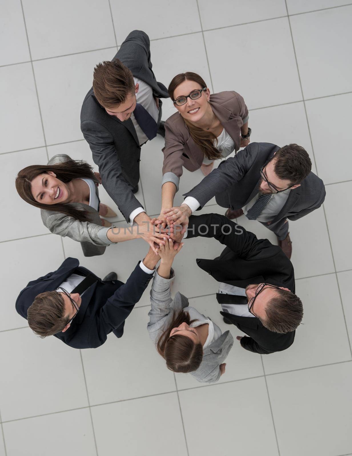top view.business team joining hands together.the concept of teamwork