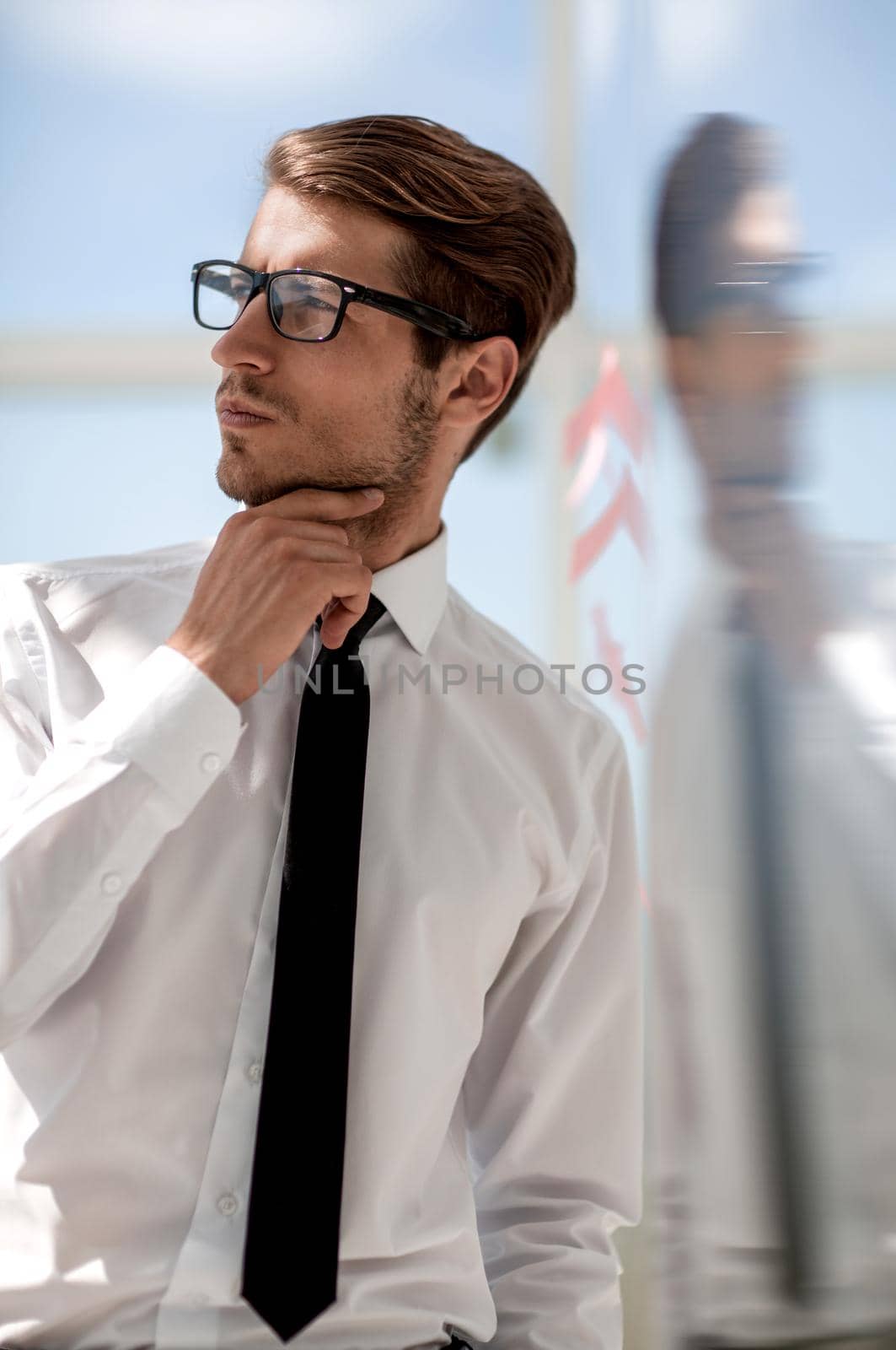 close up.pensive businessman standing in office.business people