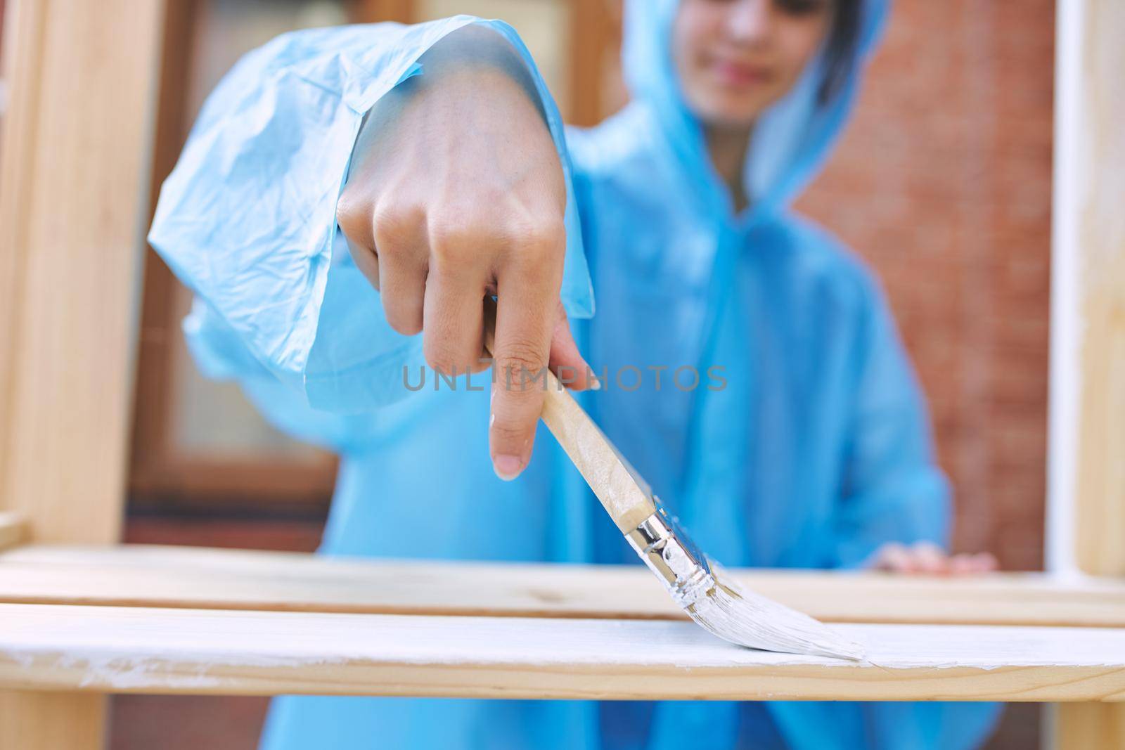 woman house painter renovating wood fittings at home. High quality photo