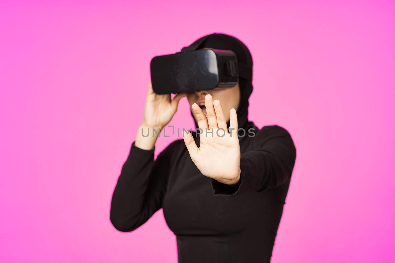 muslim woman wearing virtual reality glasses entertainment technology device. High quality photo