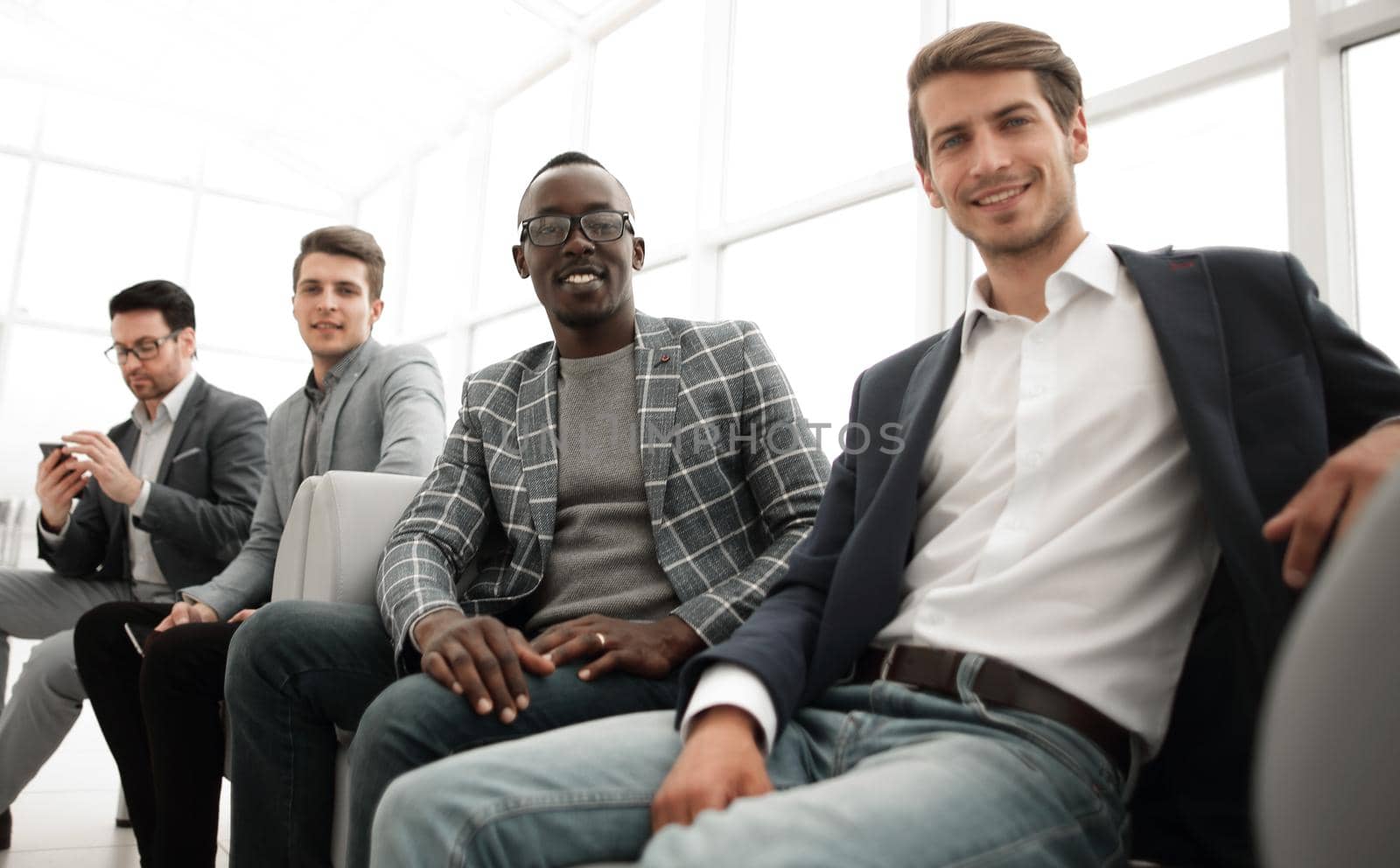 group of young business people are waiting for an interview in the office lobby.the concept of employment