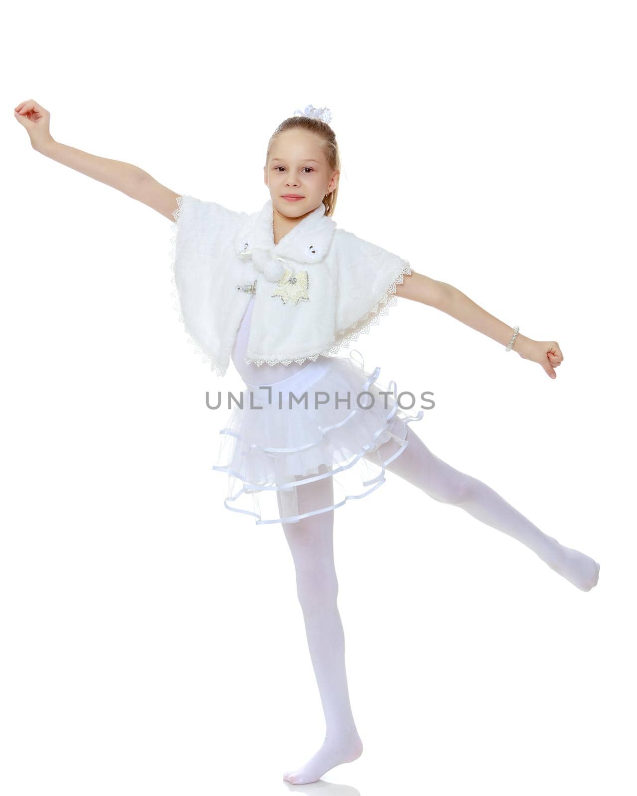 A girl gymnast balances on one leg.The concept of childhood, sport, a healthy lifestyle. Isolated on white background.