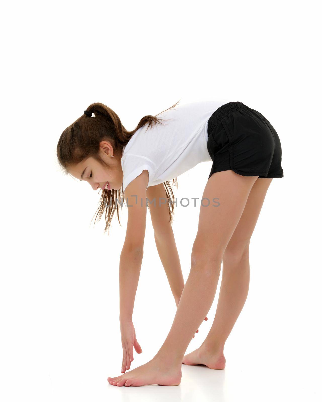 A girl gymnast performs an acrobatic element. The concept of childhood, sport, healthy lifestyle. Isolated on white background.