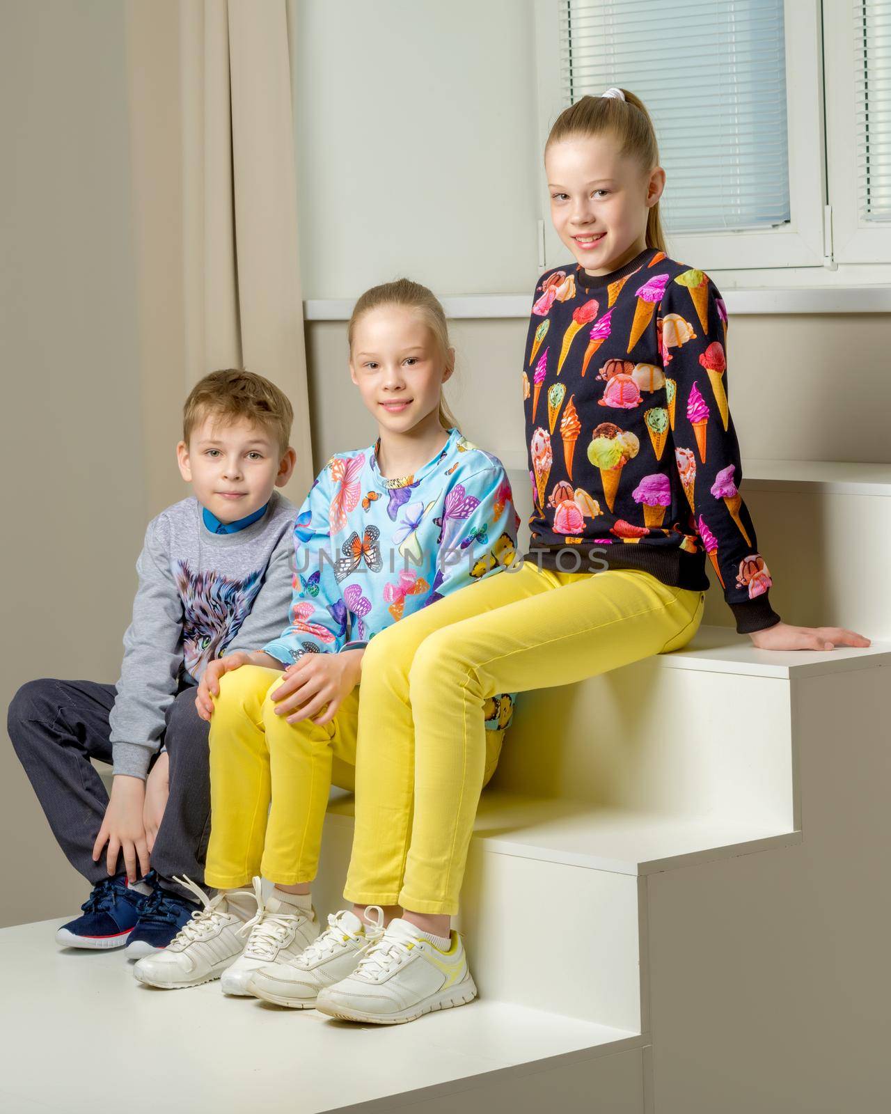 Group of happy little children posing in studio. The concept of a happy childhood, friendship.