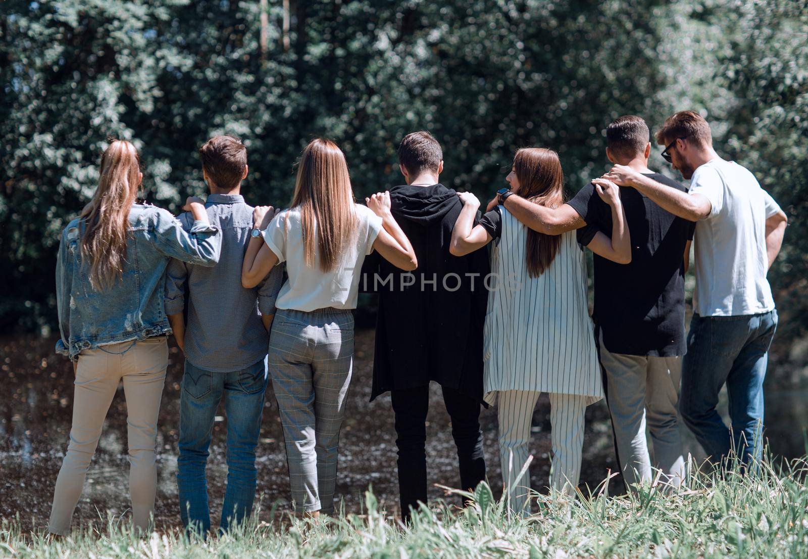 rear view. a group of young people walking in the Park. by asdf