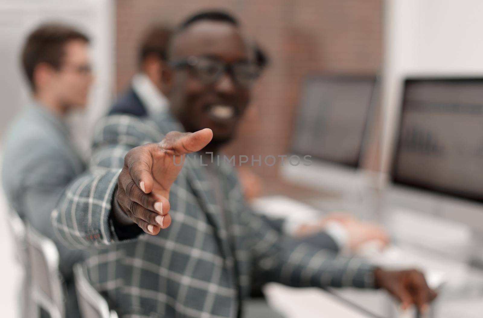 young businessman reaching out for a handshake.business concept