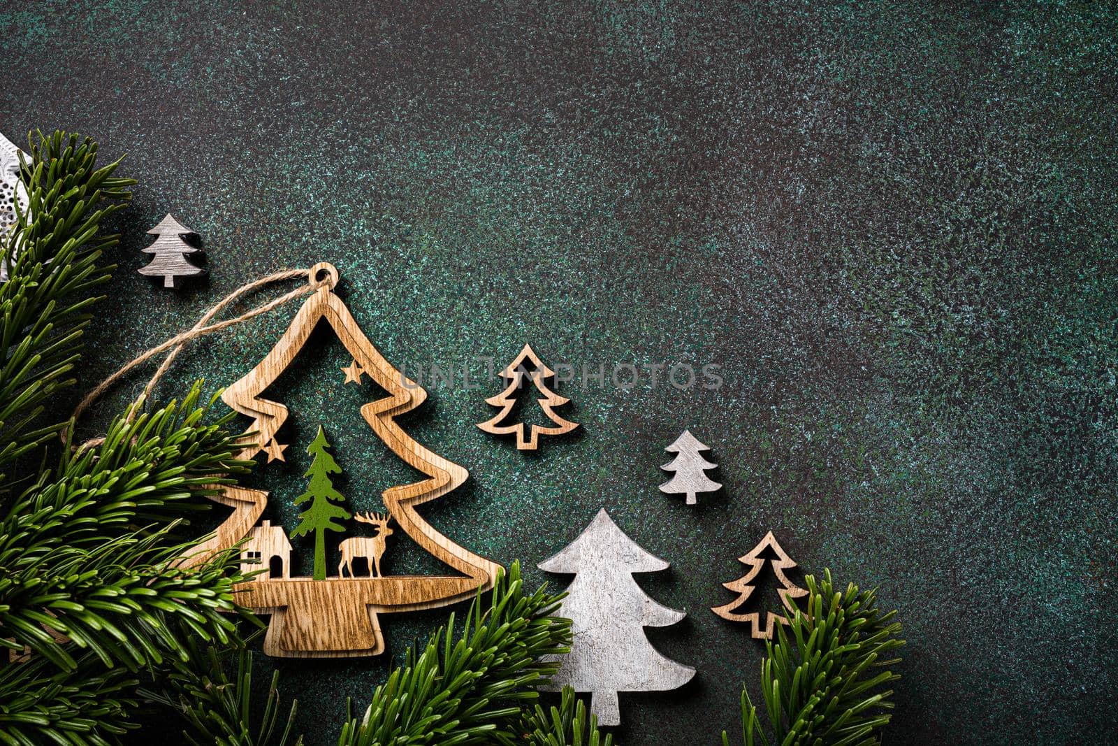 Festive background with wooden christmas tree and decoration. Copy space, winter holidays greeting card, flat lay, top view.