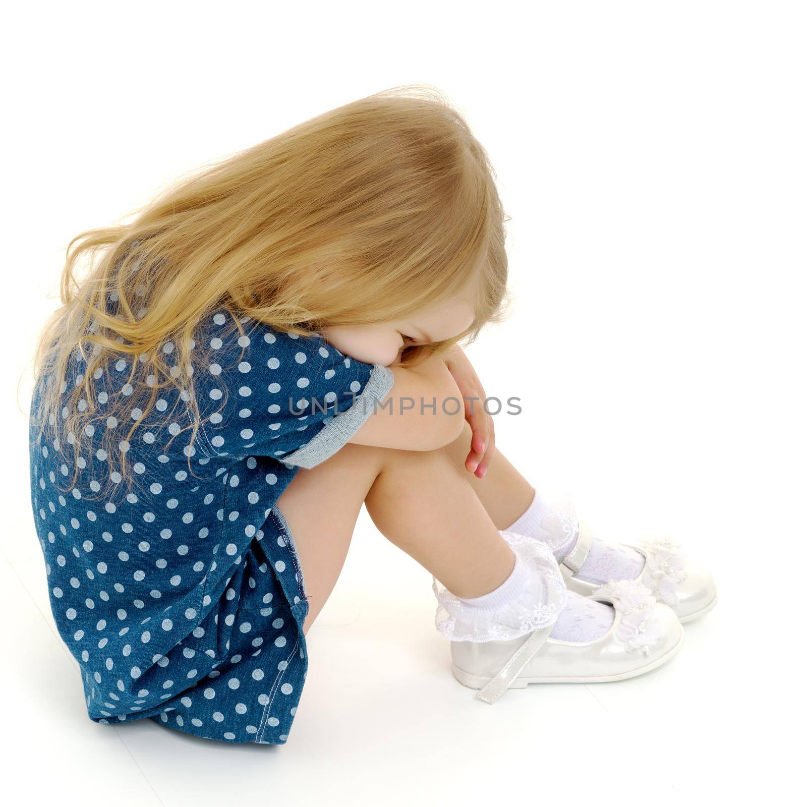 Sad little girl crying. The concept of education, relationships, children's fears. Isolated on white background.