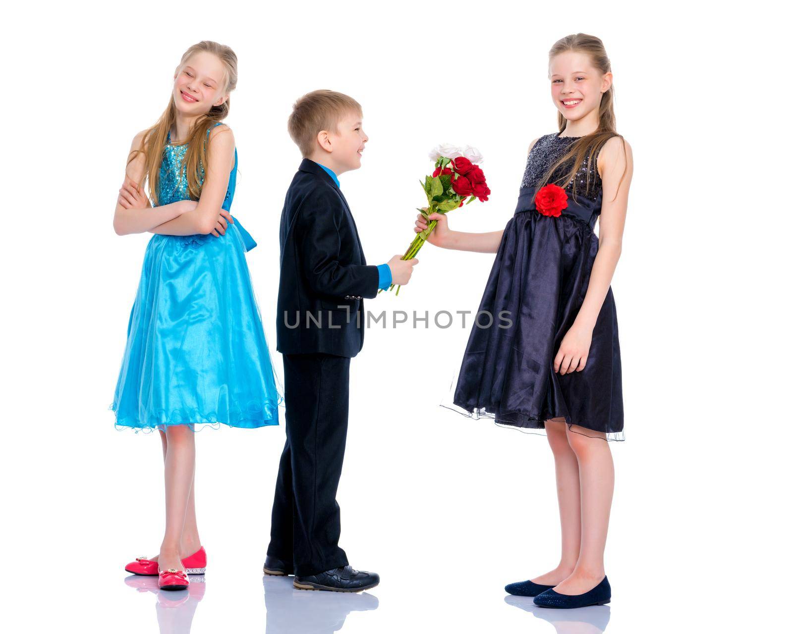 A little boy gives a little girl flowers. The concept of a happy childhood, love. Isolated on white background.