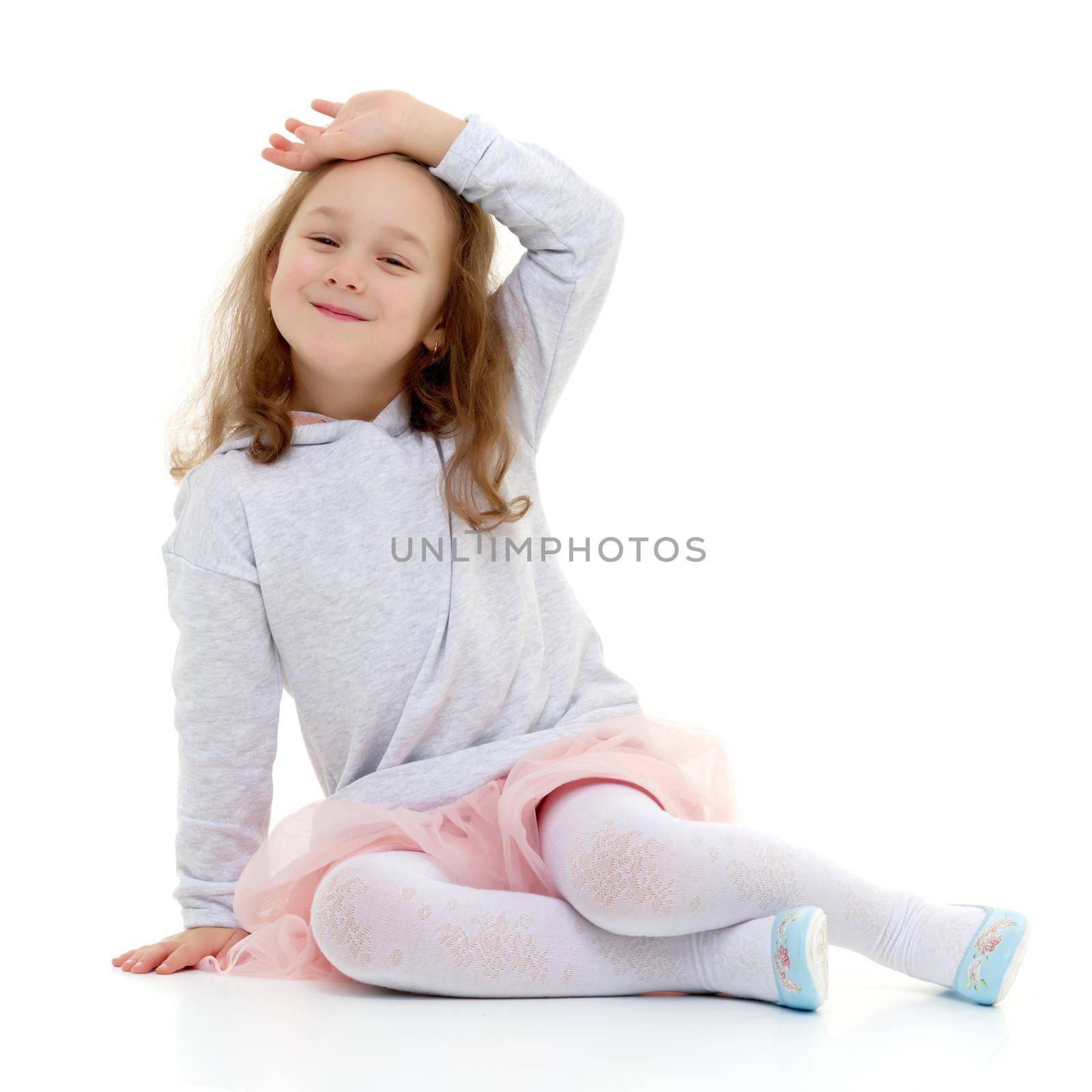 A sweet girl straightens her hair. The concept of fashion and style. Isolated over white background