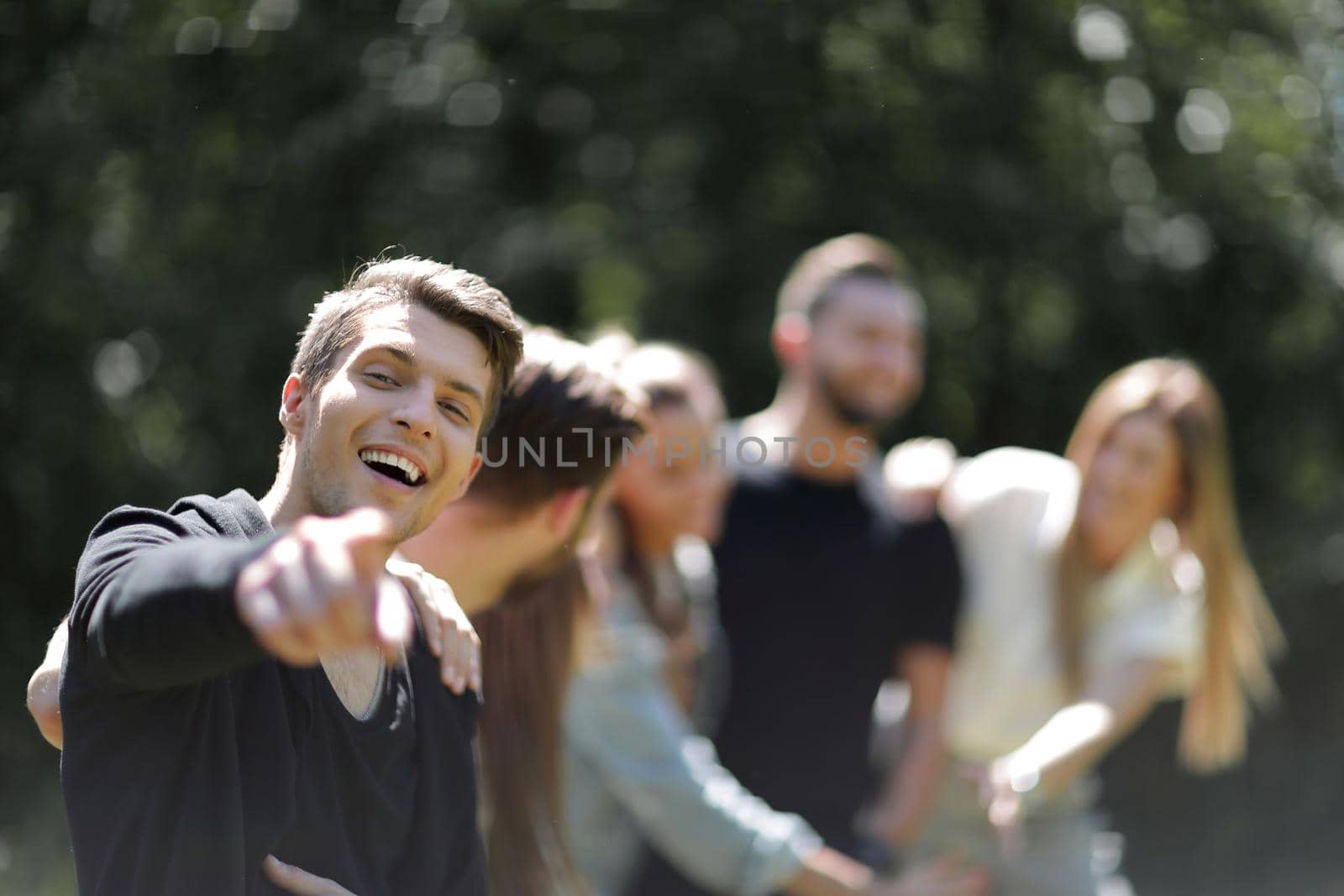 successful guy in the background of friends. successful youth