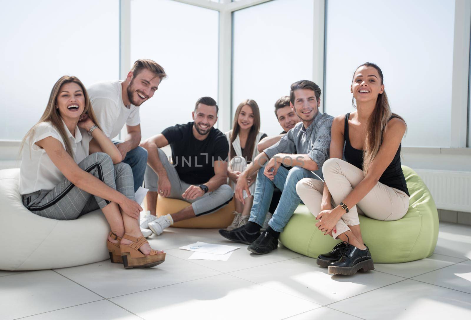 group of initiative young people sitting in the new office. the concept of a startup