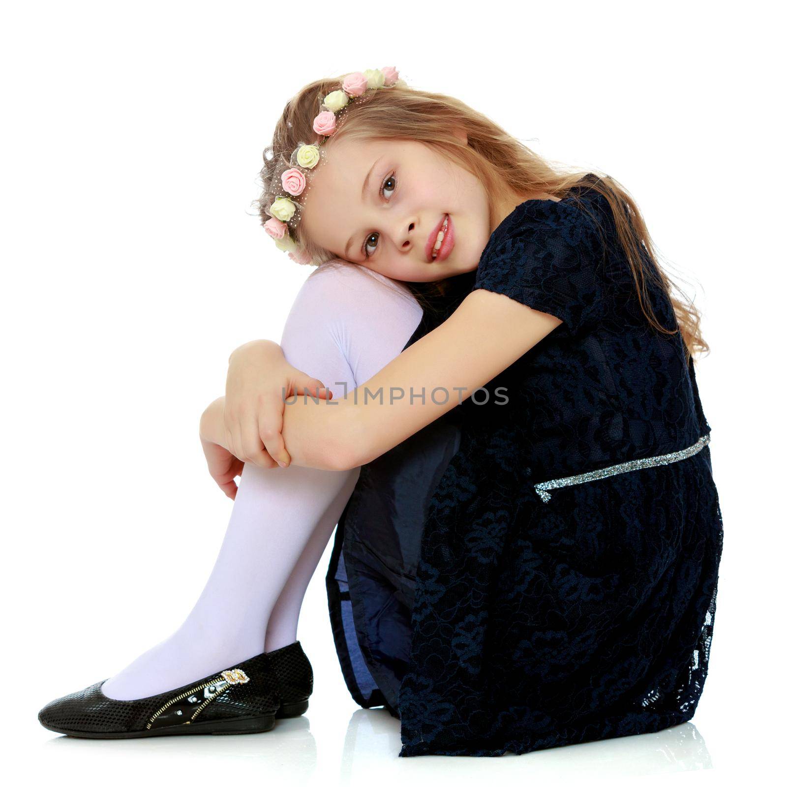 Little girl hugging her knees. by kolesnikov_studio