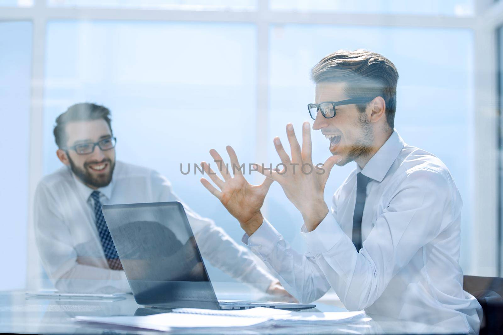 Excited employees enjoying the good news on the Internet.the concept of victory