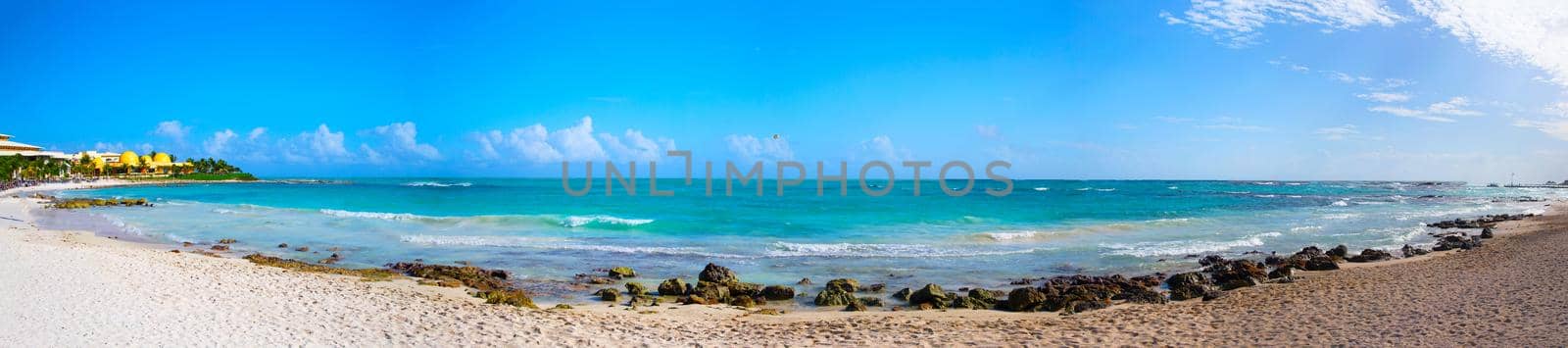 Sandy tropical beach on a hot sunny day. Panorama. Coast of Mexico.