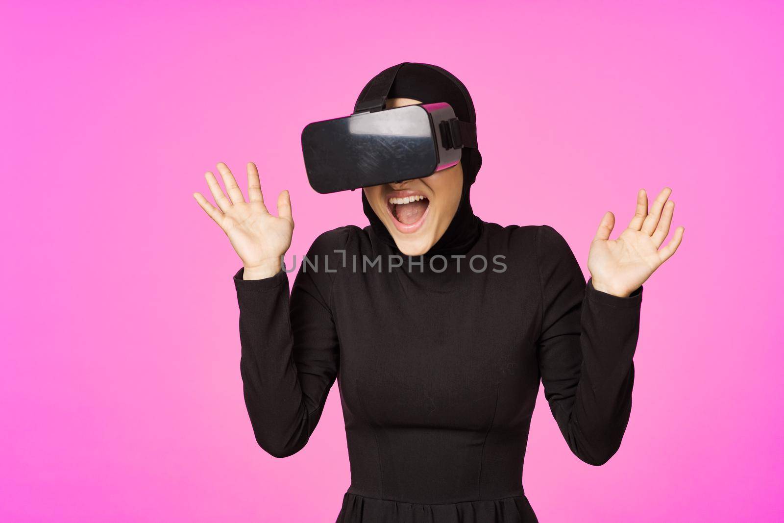 woman in black hijab glasses virtual reality technology movie watching. High quality photo