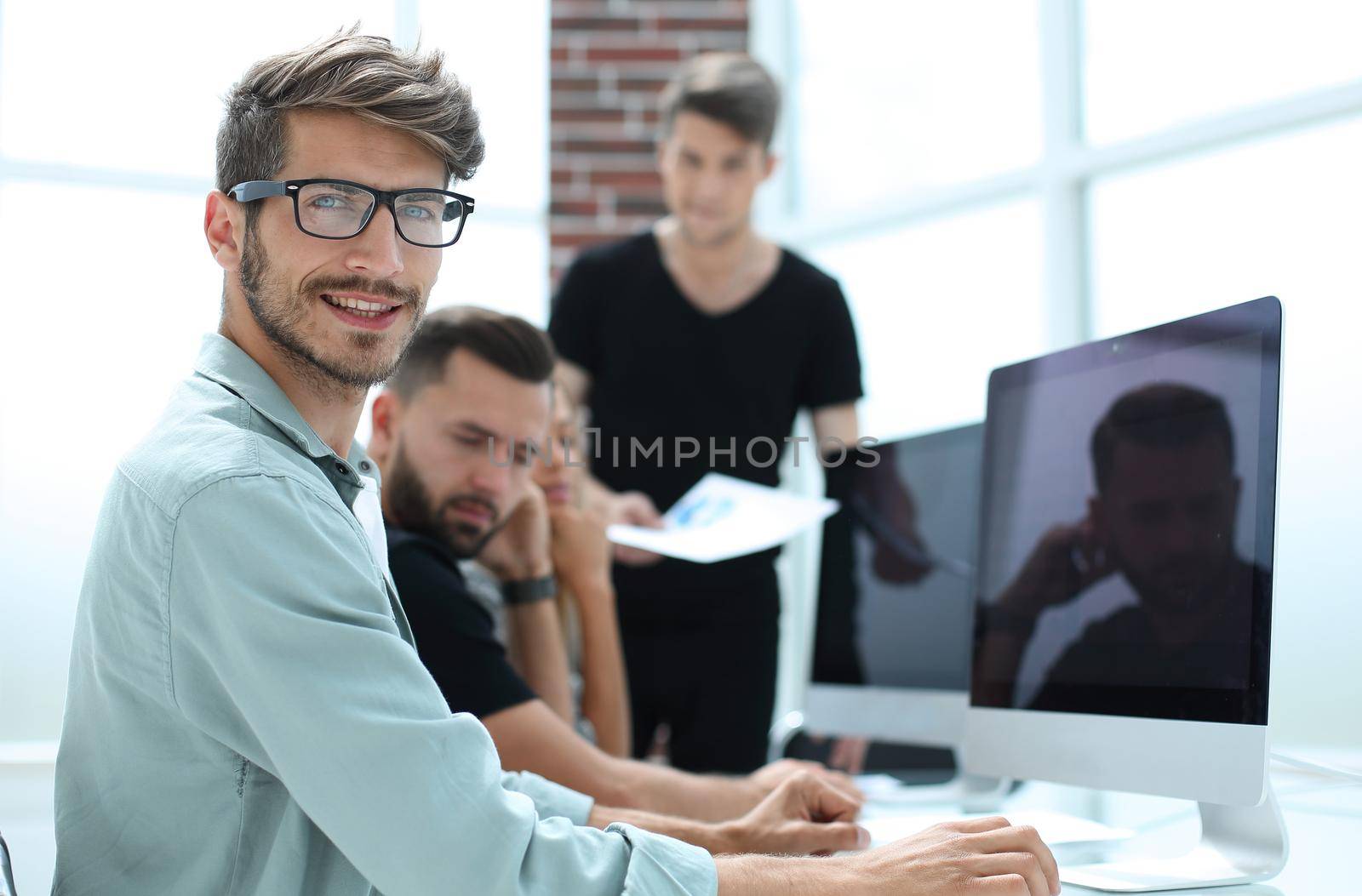 Creative people doing a brainstorming meeting in a modern studio