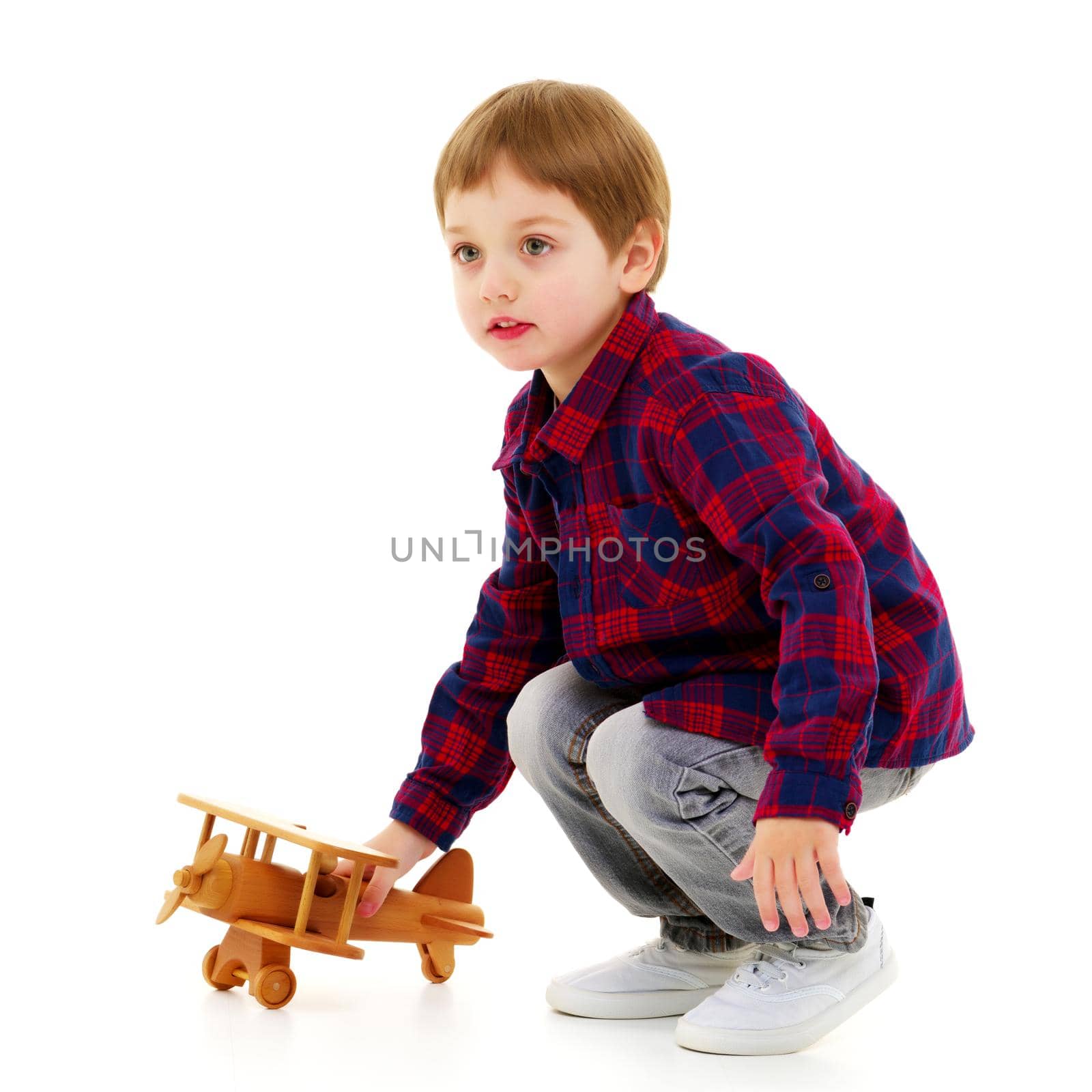 Little boy playing with wooden plane by kolesnikov_studio