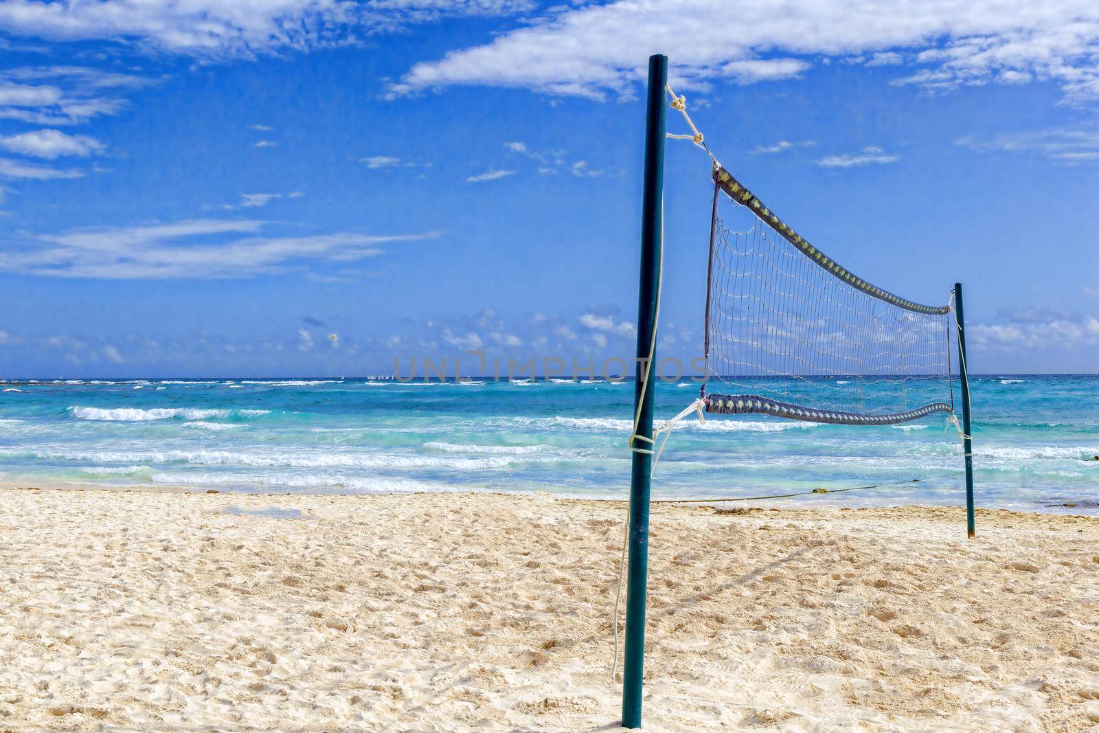 Lonely volleyball net on a sandy beach, on the shores of the tropical sea. The concept of outdoor activities, sports.