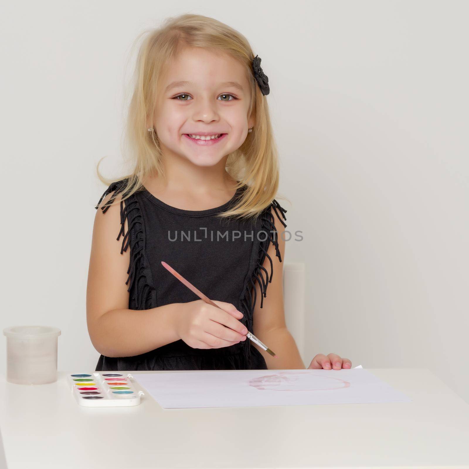 Joyful little girl draws a brush. by kolesnikov_studio