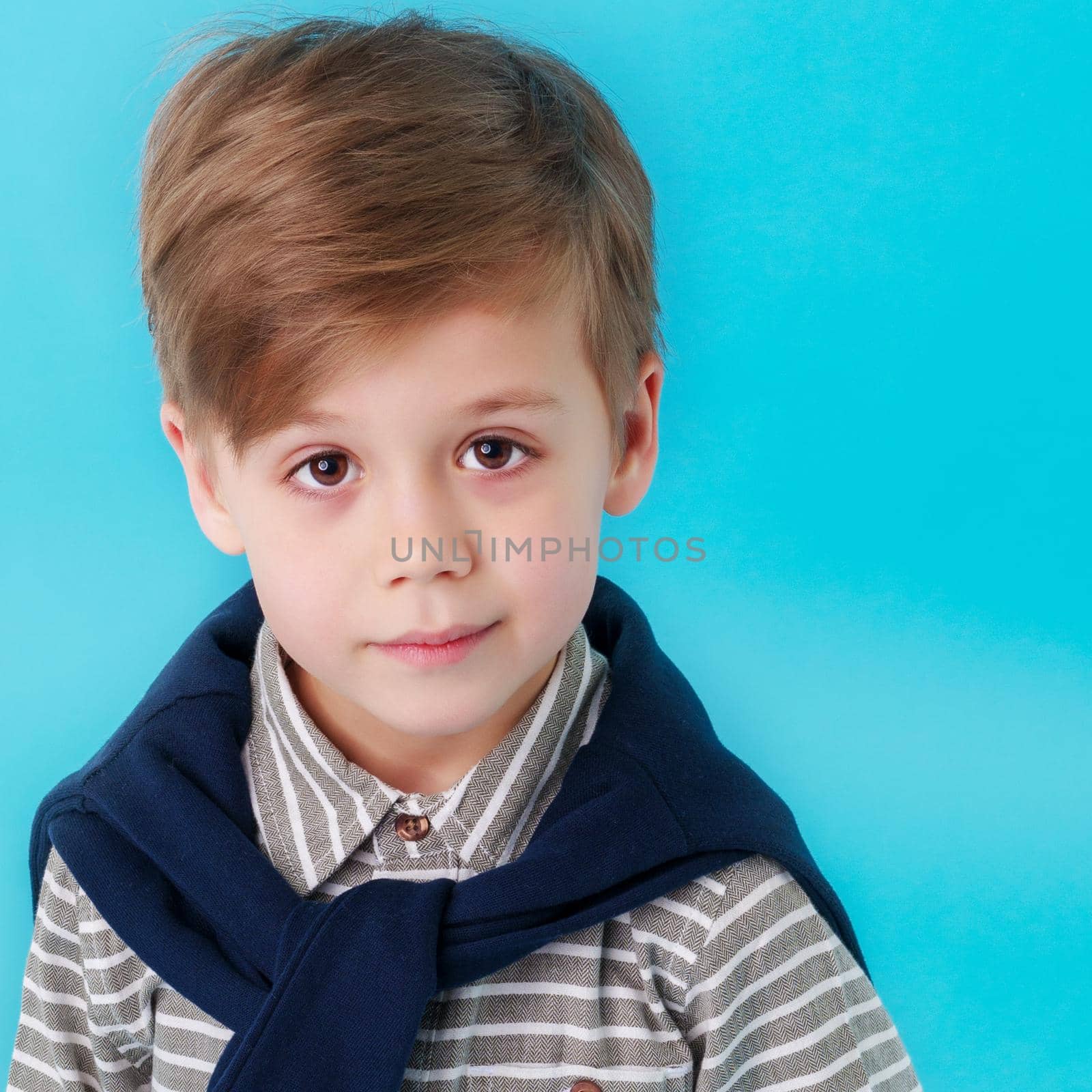 Cute little boy studio portrait close-up. The concept of a happy childhood, advertising goods. Isolated.