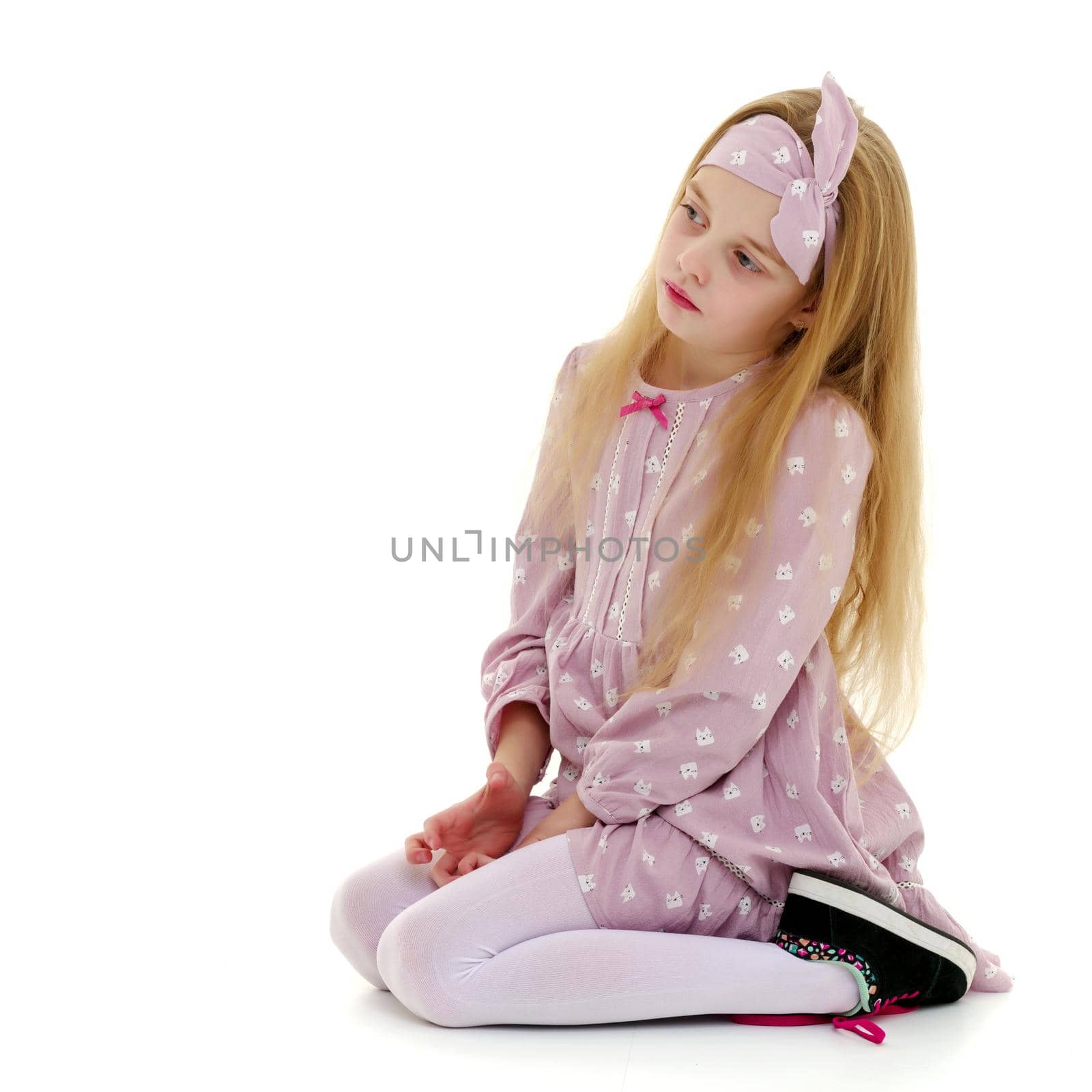 The little girl is on her knees. by kolesnikov_studio