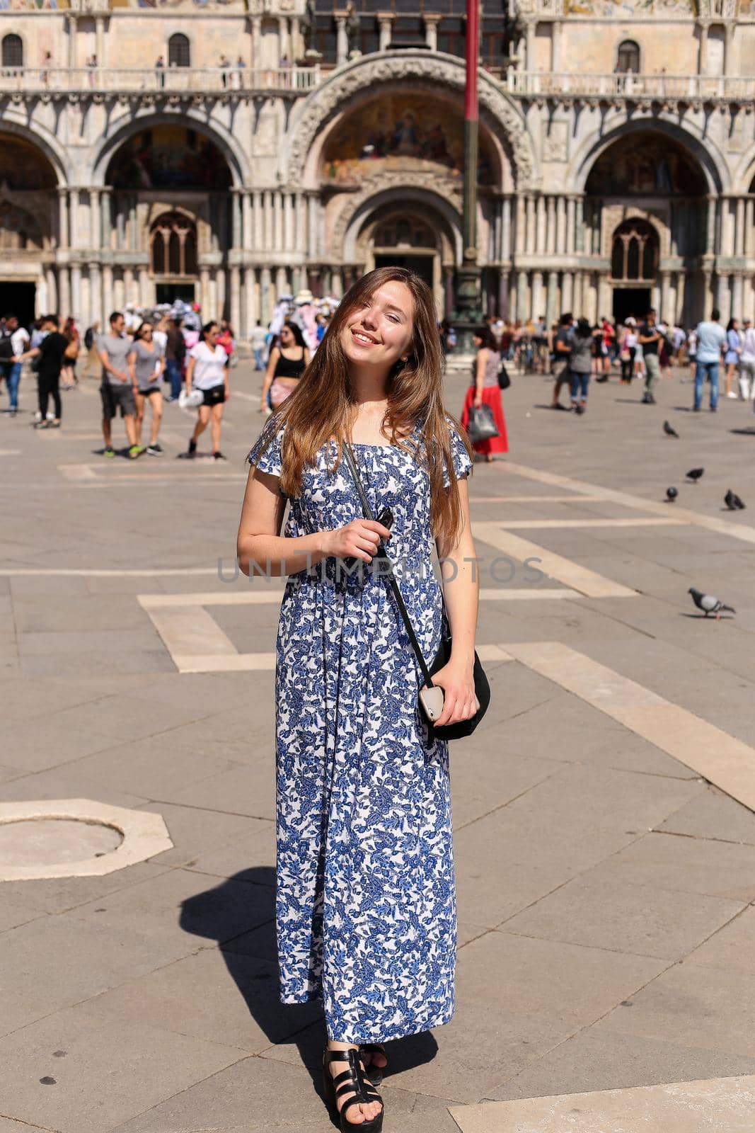 Woman standing on piazza San Marco in Venice, Italy. by sisterspro