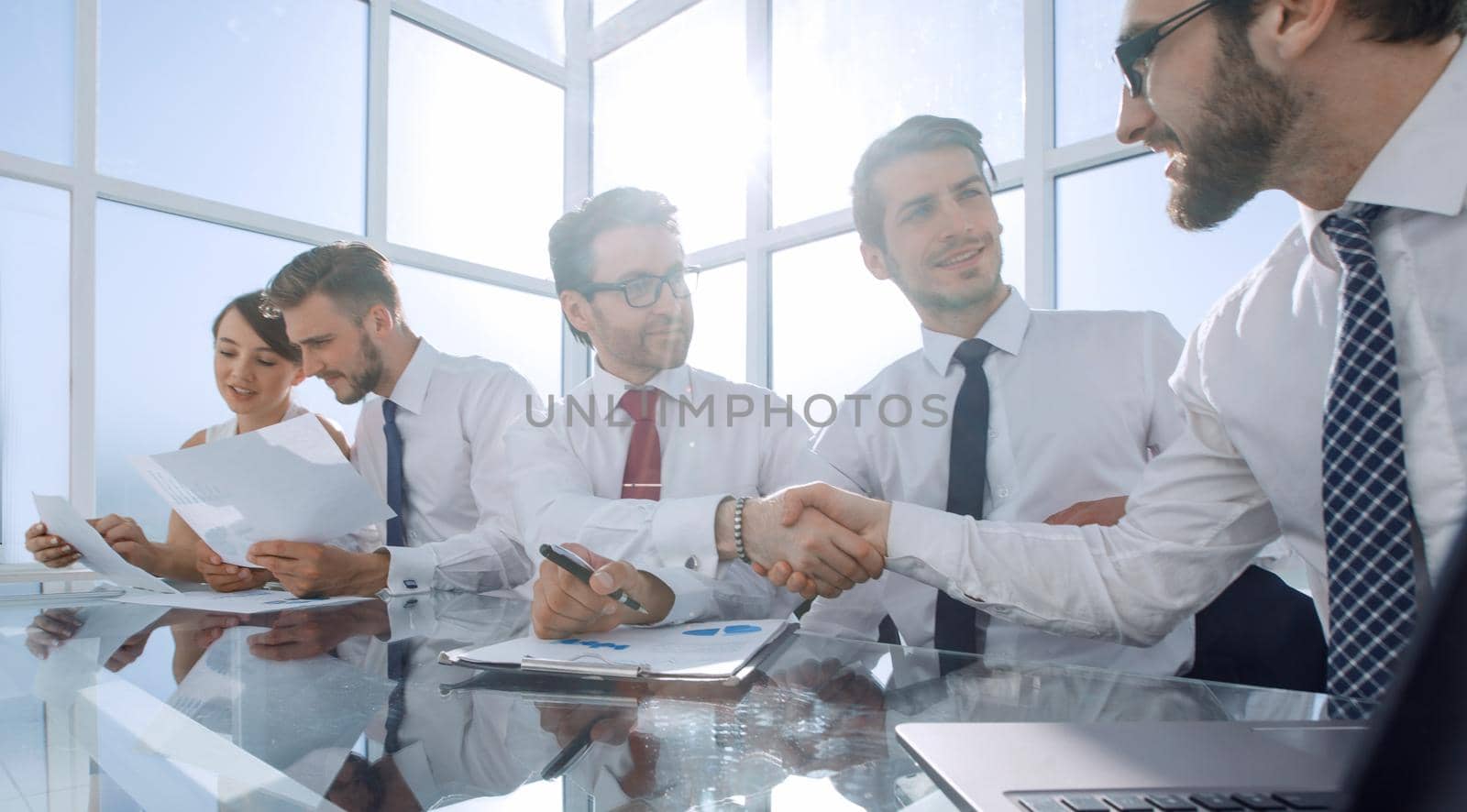 handshake colleagues at a working meeting by asdf