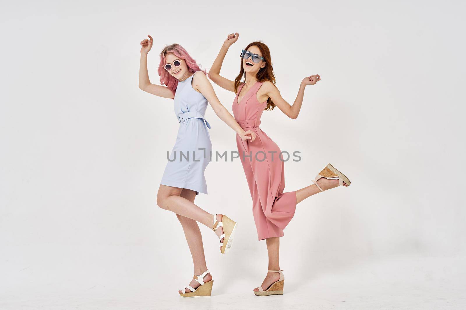 two girlfriends stand side by side fashion clothing glamor posing by Vichizh