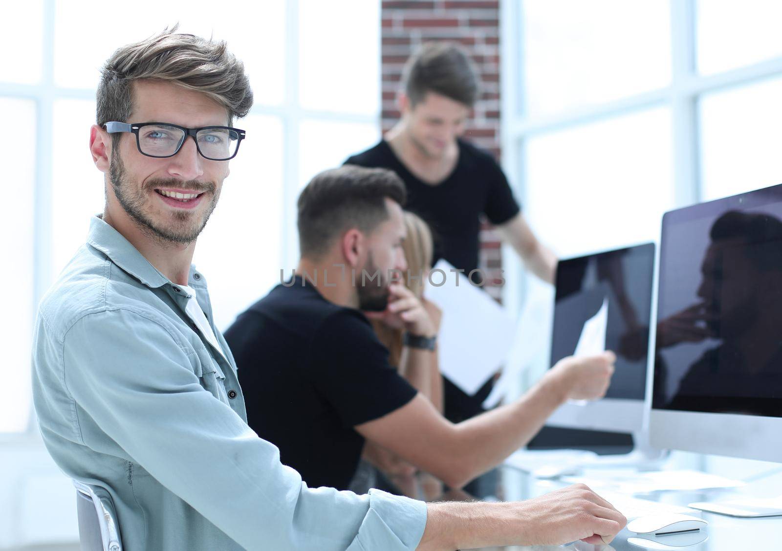 Creative people doing a brainstorming meeting in a modern studio