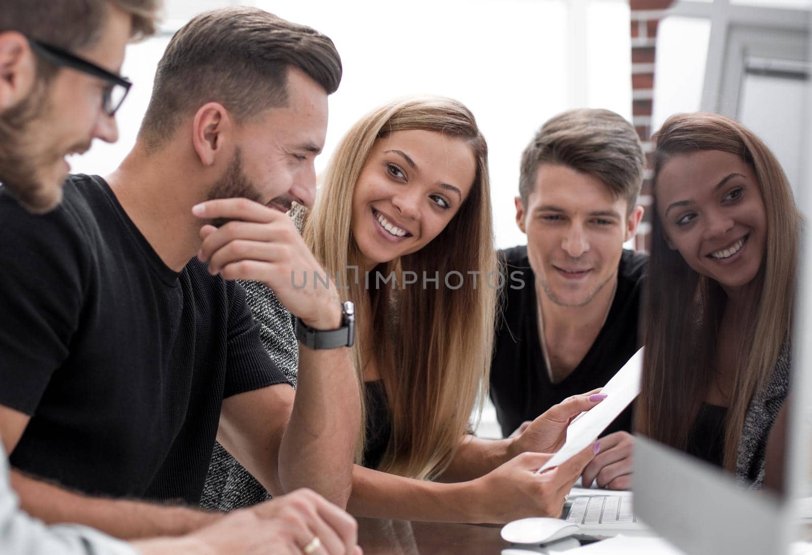 Group of three people analyze data on desktop computer. by asdf