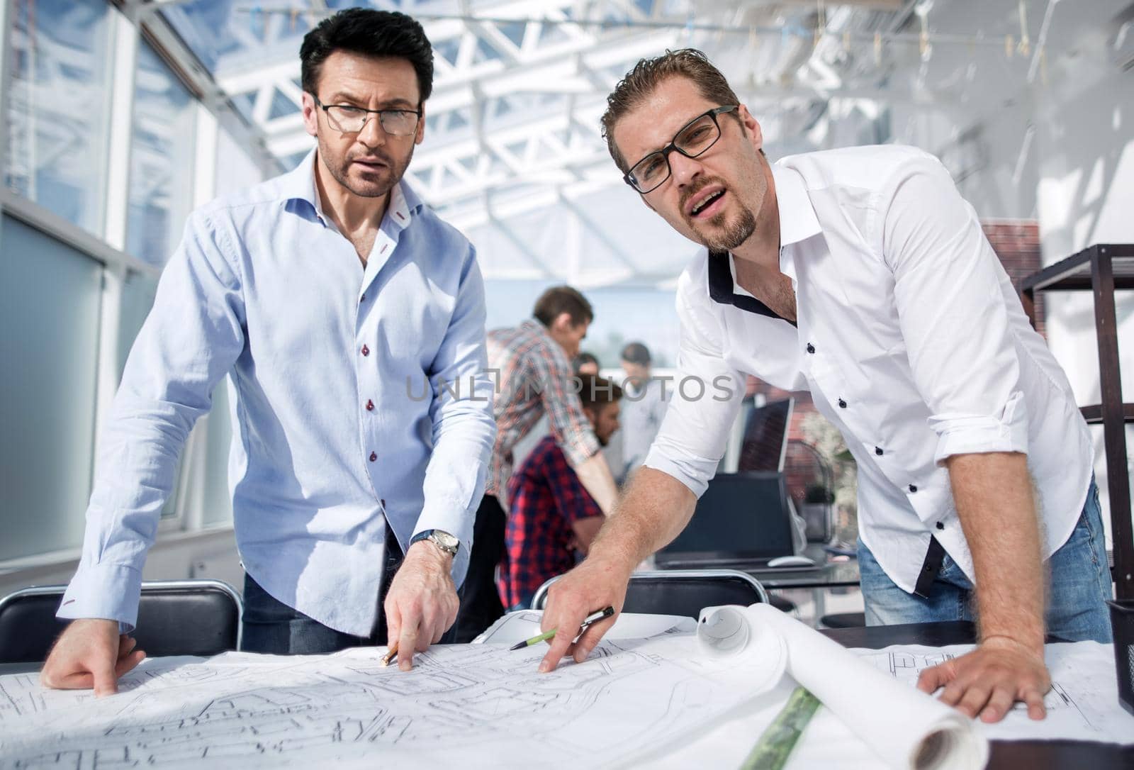 close up.professional designers standing at the workplace .the concept of professionalism