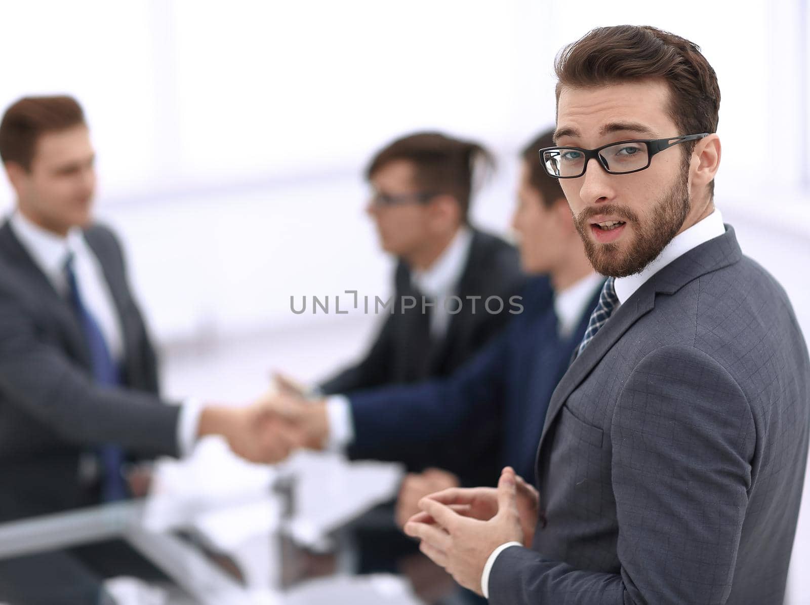 smiling businessman on blurred office background.