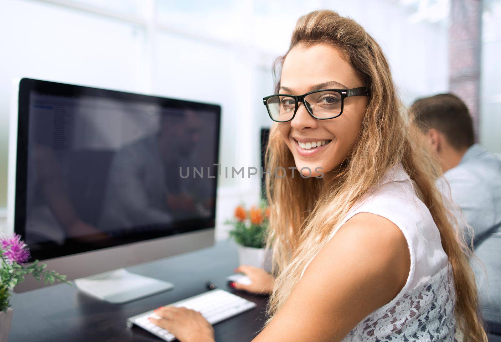 young business woman working on office computer by asdf