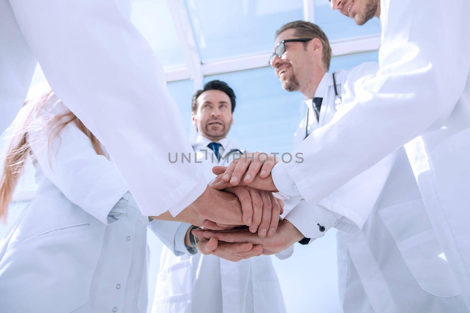 bottom view. close up of a doctors folded their hands together.concept of teamwork