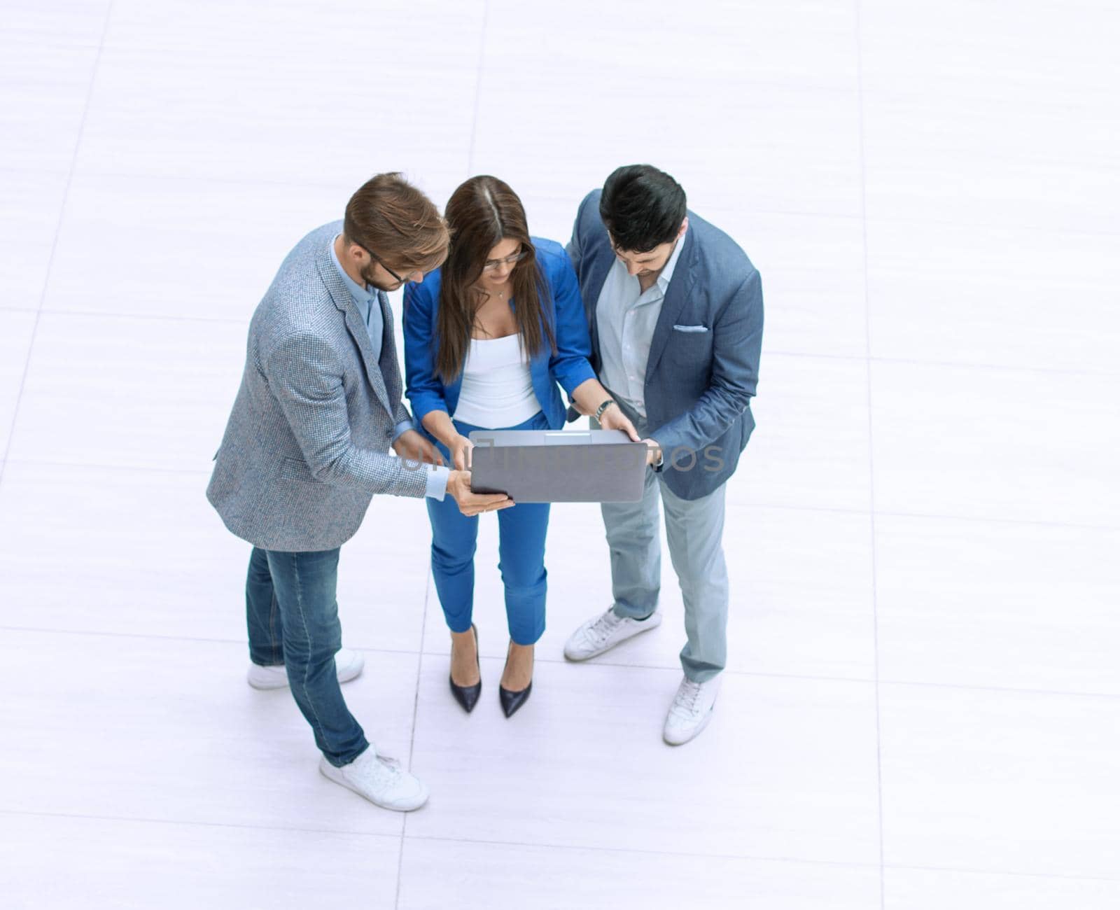 top view.the business team looks at the laptop screen by asdf