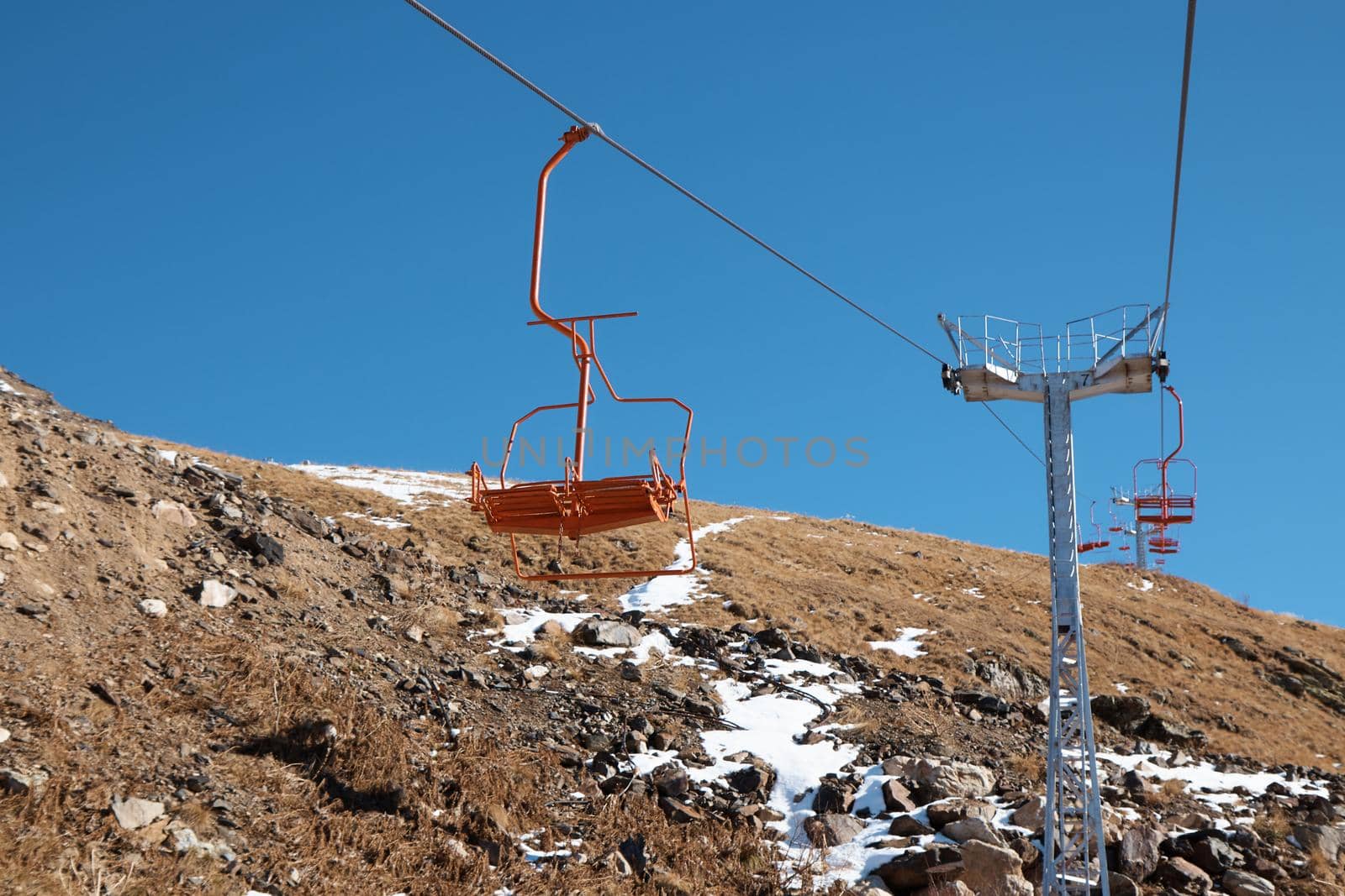 High quality photo about Dombay, alps, chairlift, ski lift, first snow in the mountains, sun and good weather, winter ski season