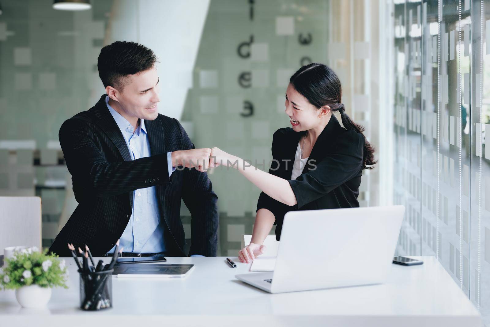 Business Success concept with partner, Partnership Giving Fist Bump after Complete a deal. Successful Teamwork, Businessman with Team Agreement in Corporate. by Manastrong