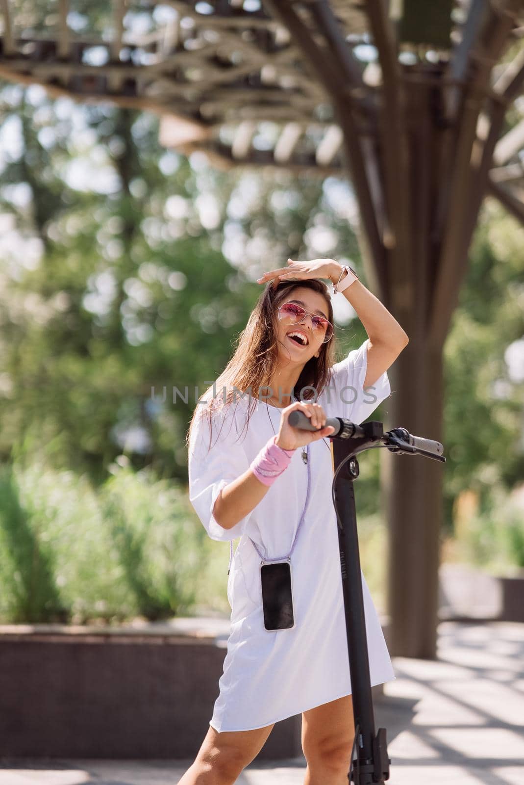 Young beautiful woman and an electric scooter, modern girl, new generation, electric transport, ecological transport