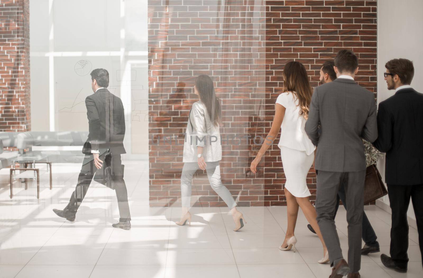 employees walking through the office hall by asdf