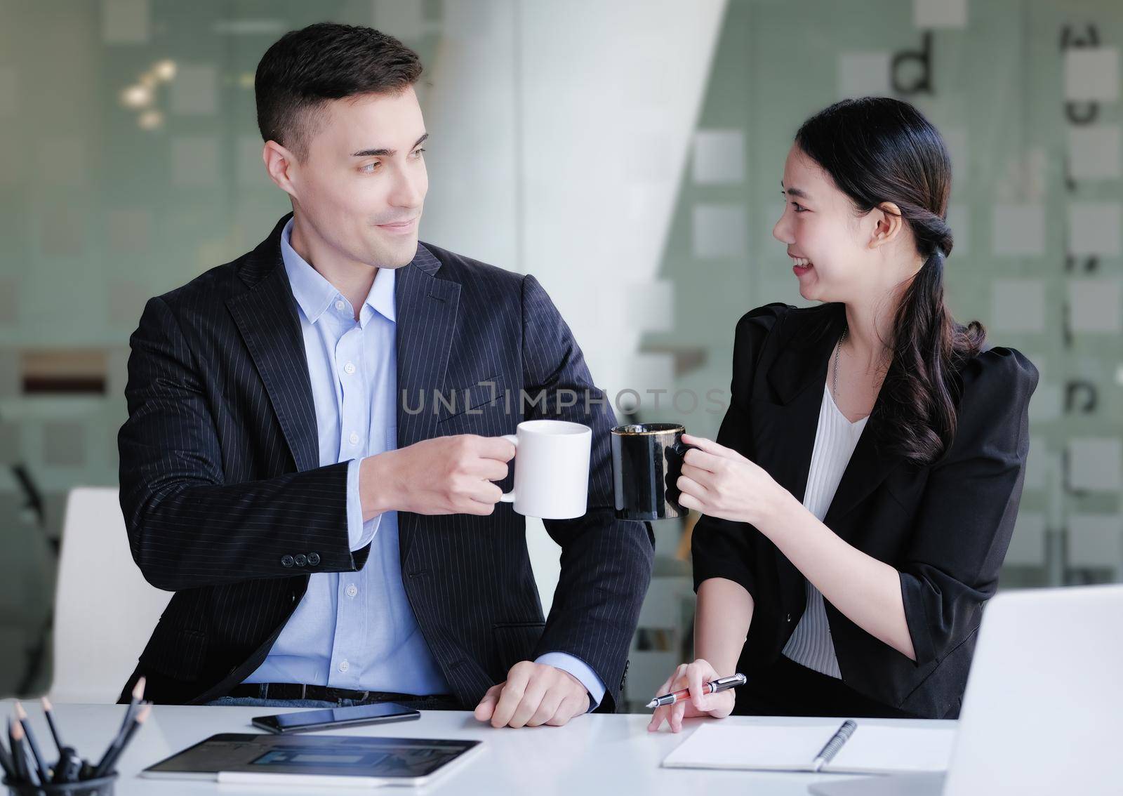 A company employee of the planning and investment department sits on a coffee break and discusses the company's budget. by Manastrong