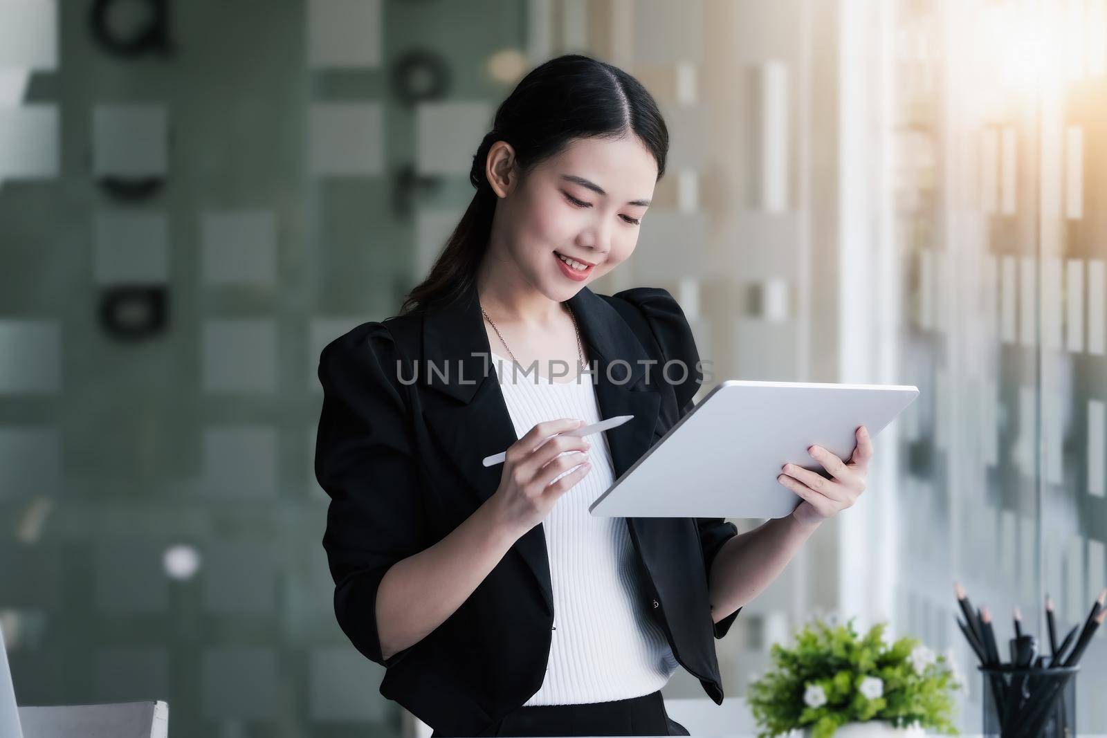 Business owners are using a computer tablet. in managing financial statements to adjust the company's financial structure