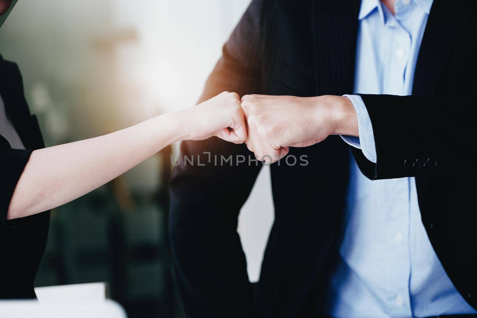 Business Success concept with partner, Partnership Giving Fist Bump after Complete a deal. Successful Teamwork, Businessman with Team Agreement in Corporate