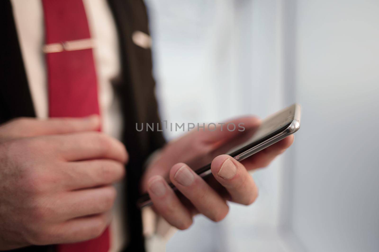 close up.businessman reading text message on smartphone.people and technology